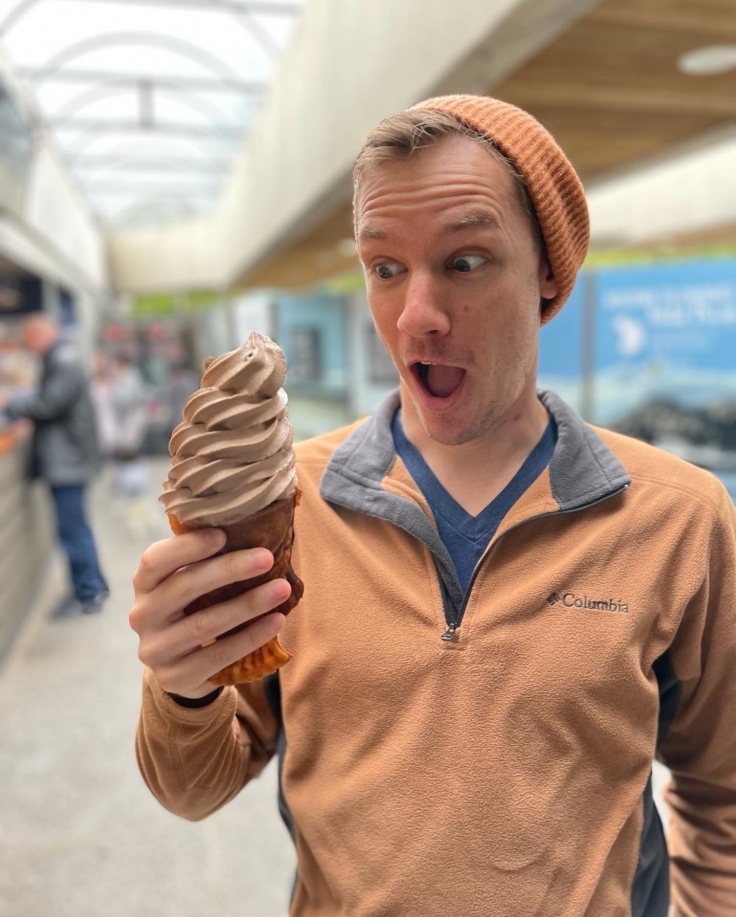 Nate Bauer looking amazed at a tall cone of ice cream